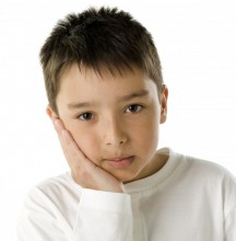 Boy with hand on face